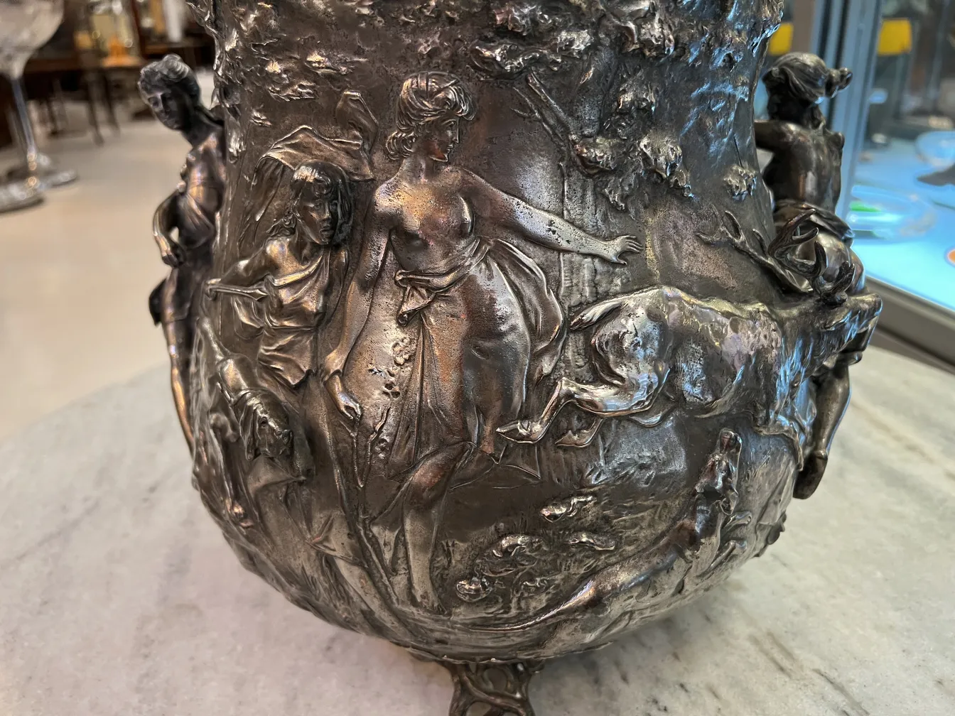 Antique WMF punch bowl with raised mythological scenes, elegant design.