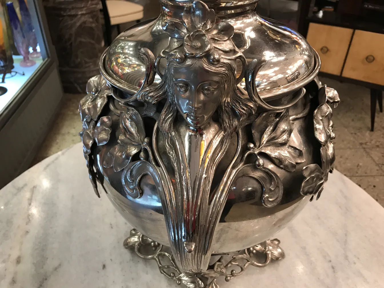 antique wmfs punch bowl with detailed floral decoration on the body, light background