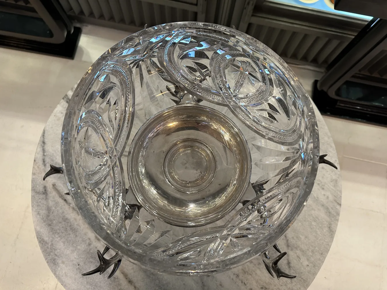 antique WMF punch bowl with intricate engravings and decorative feet in an elegant setting