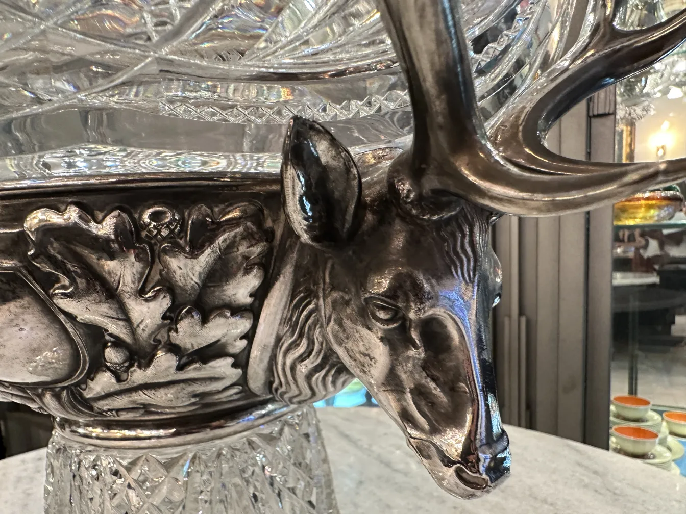 Antique WMF punch bowl with deer and leaf designs, intricate details.