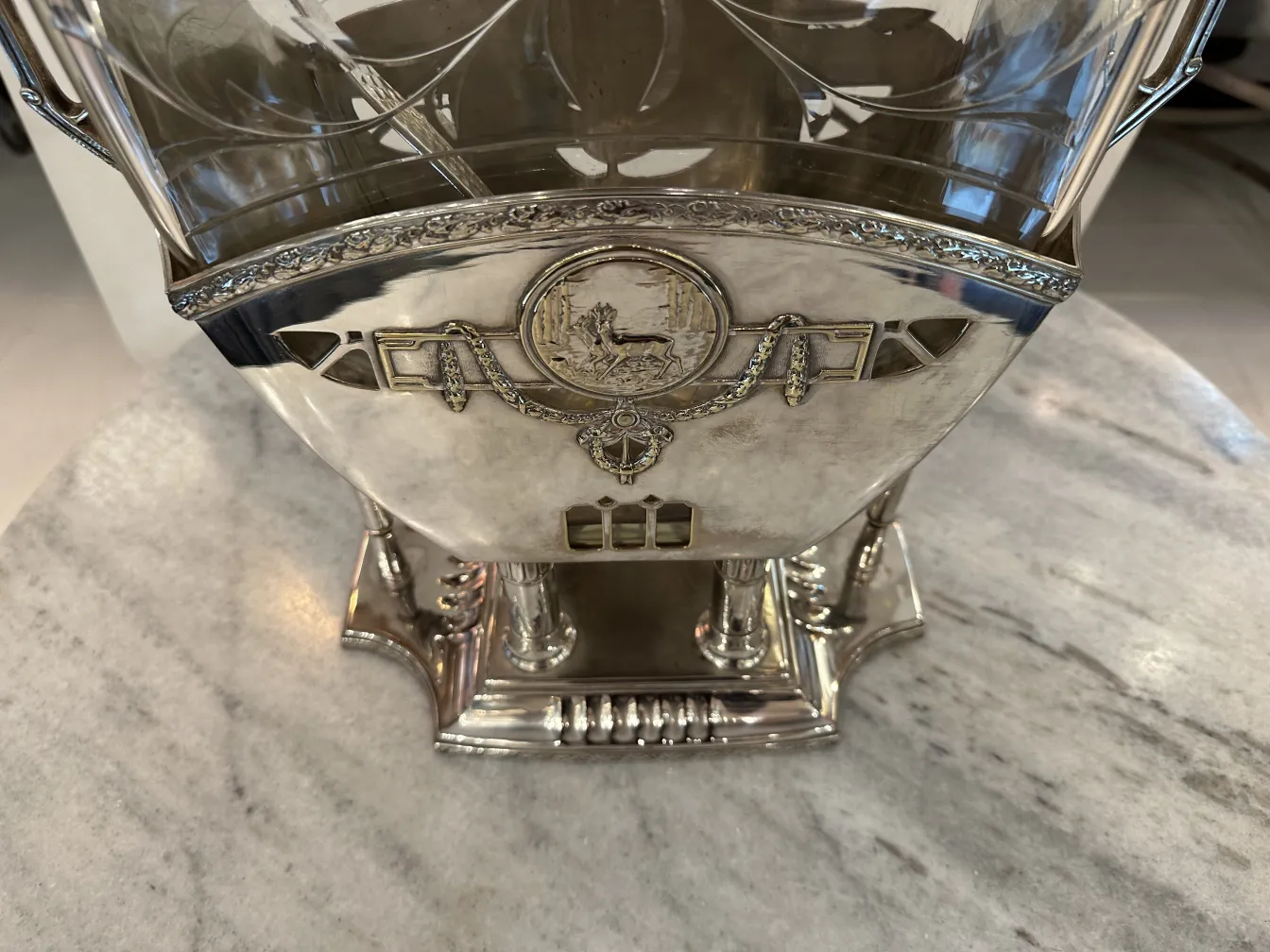 Antique decorative punch bowl WMF with intricate design, resting on a table. Elegant atmosphere.