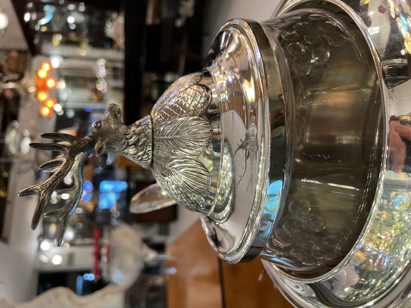 Antique WMF punch bowl adorned with a deer, gleaming in an elegant setting.