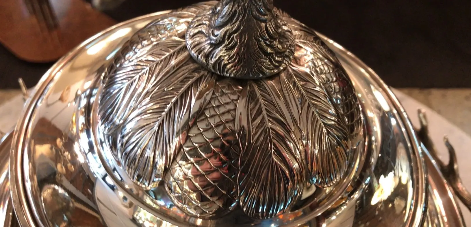 antique WMF punch bowl with relief detail on the lid, warm ambiance