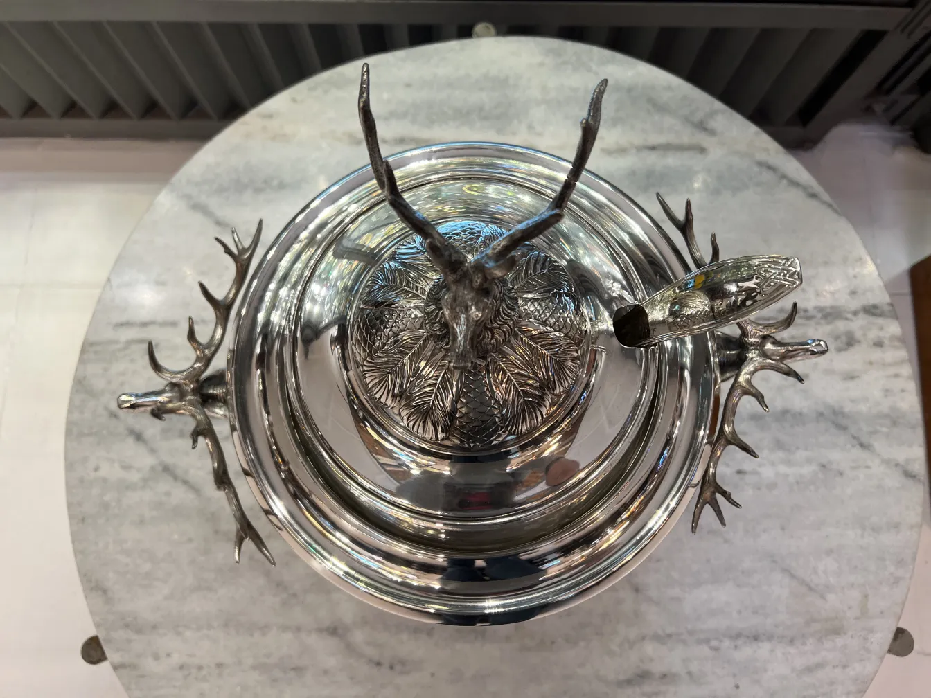 Antique WMF punch bowl with deer design, perfect for gatherings.