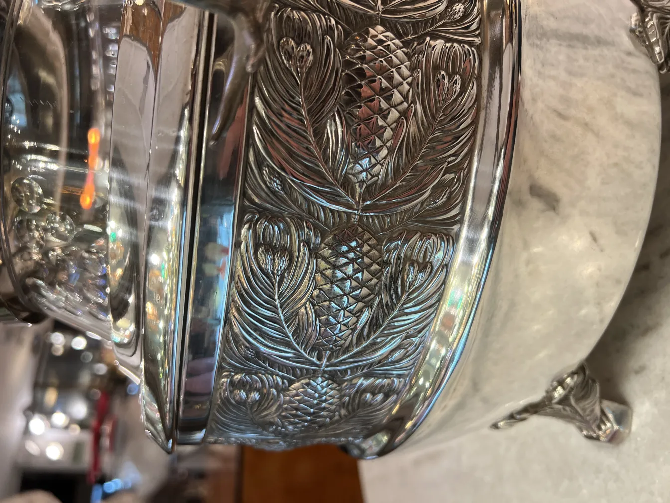 antique WMF punch bowl with shiny pine design, decorative, in an elegant setting with soft lights.