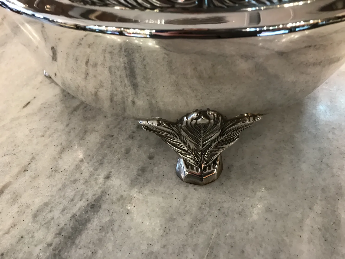 antique WMF punch bowl with decorative feet, side view