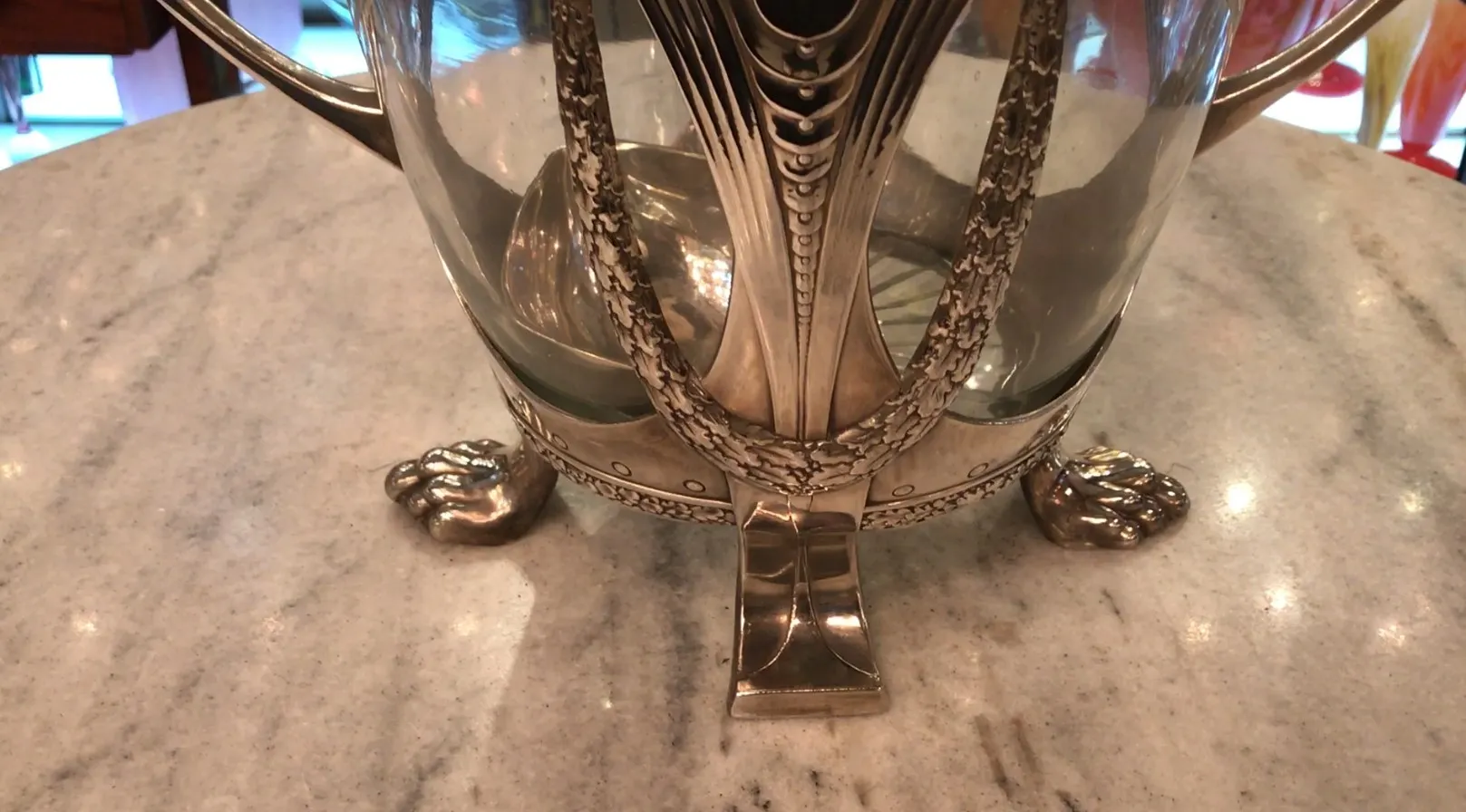 Antique WMF punch bowl with decorative feet, elegant design.