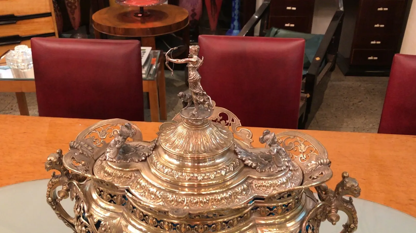 Antique WMF punch bowl featuring ornate designs and artistic sculptures on the lid.