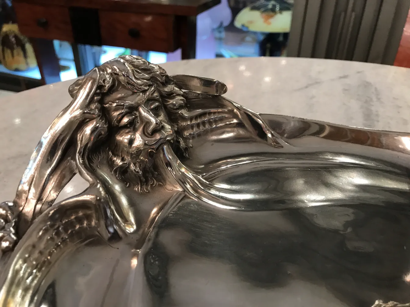 antique WMF card tray with ornate edge decorations and shiny surface