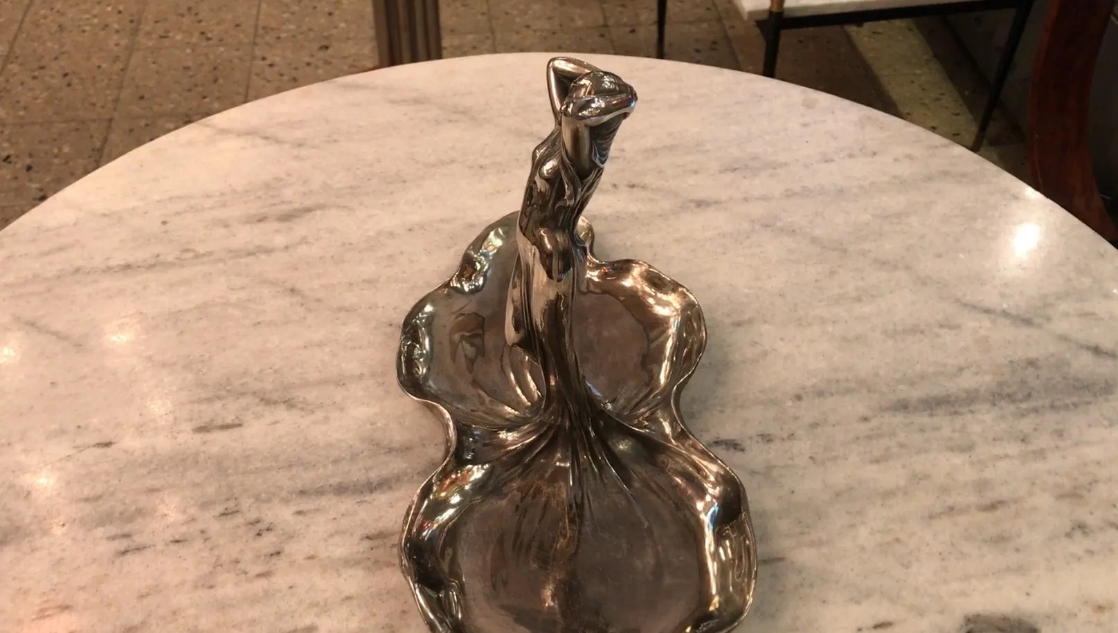 antique WMF card tray with artistic shape and shiny details.