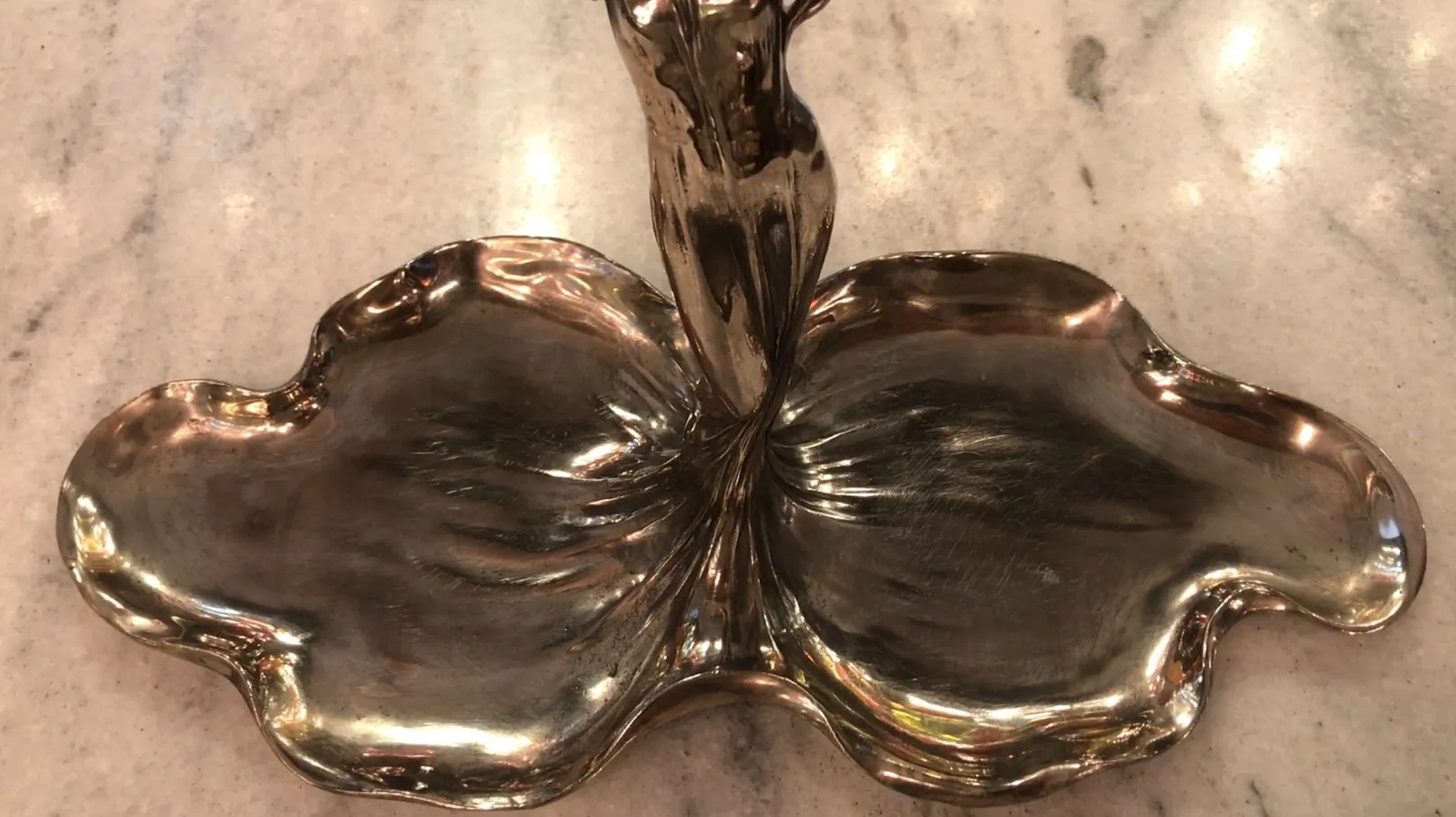 antique WMF card tray with elegant shape and decorative details in a warm setting