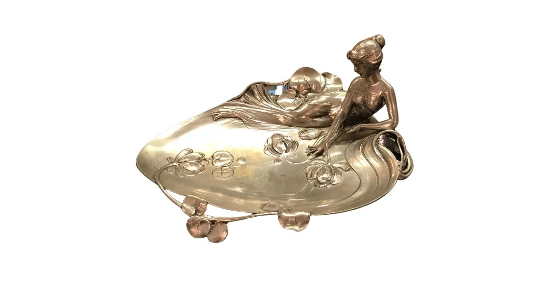 antique WMF card tray with decorative figure and floral details