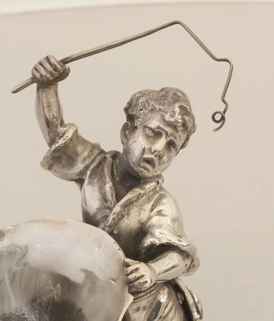 antique WMF card tray featuring a figure of a child