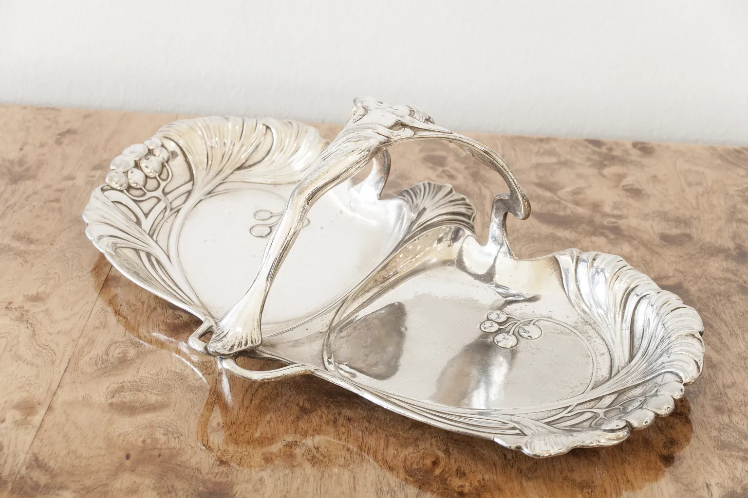 Antique WMF card tray with floral design, featuring an elegant handle.