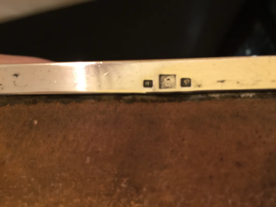 side view of two antique jewelers on a wooden base