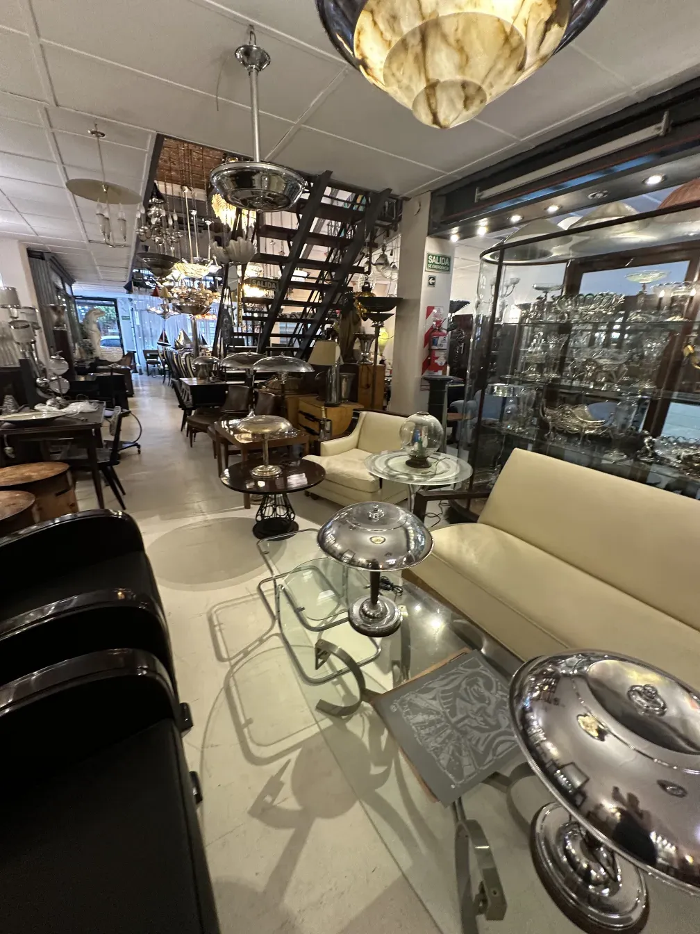 Antique armchair with comfortable design, surrounded by various elegant furniture.