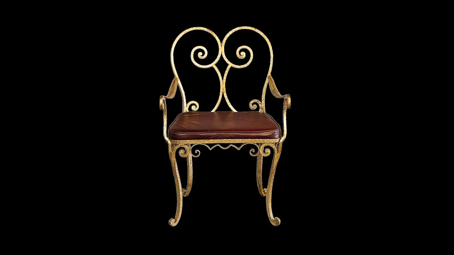 Antique armchair with ornate design, brown seat, black background.