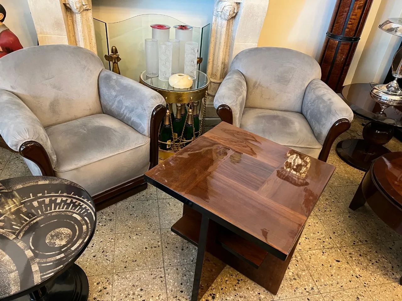 Two antique armchairs in a cozy setting, with a small table