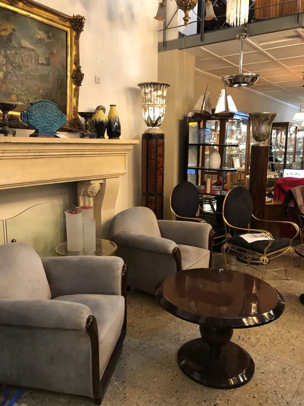 Front view of 2 antique armchairs in a cozy setting