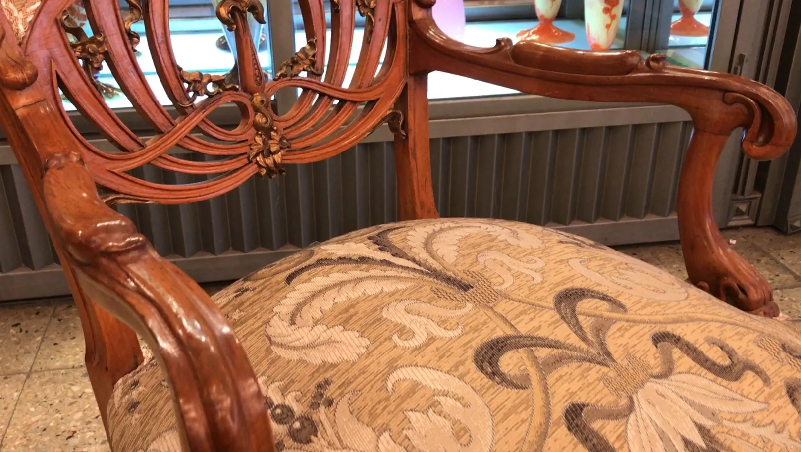 Three art nouveau style armchairs with decorative embellishments, cozy atmosphere