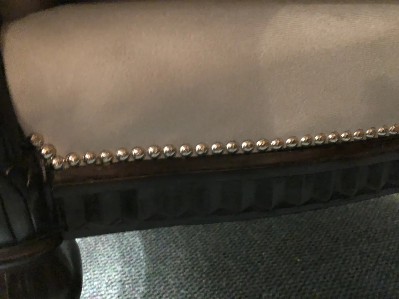 Detail of 3 antique armchairs with decorative studs