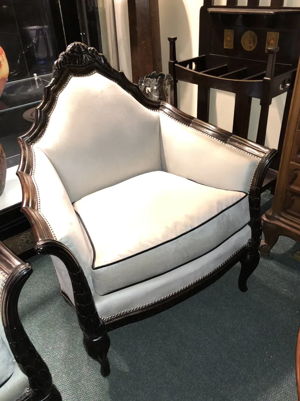 Three antique armchairs by Paul Follot with elegant design, featuring light colors and fine details.