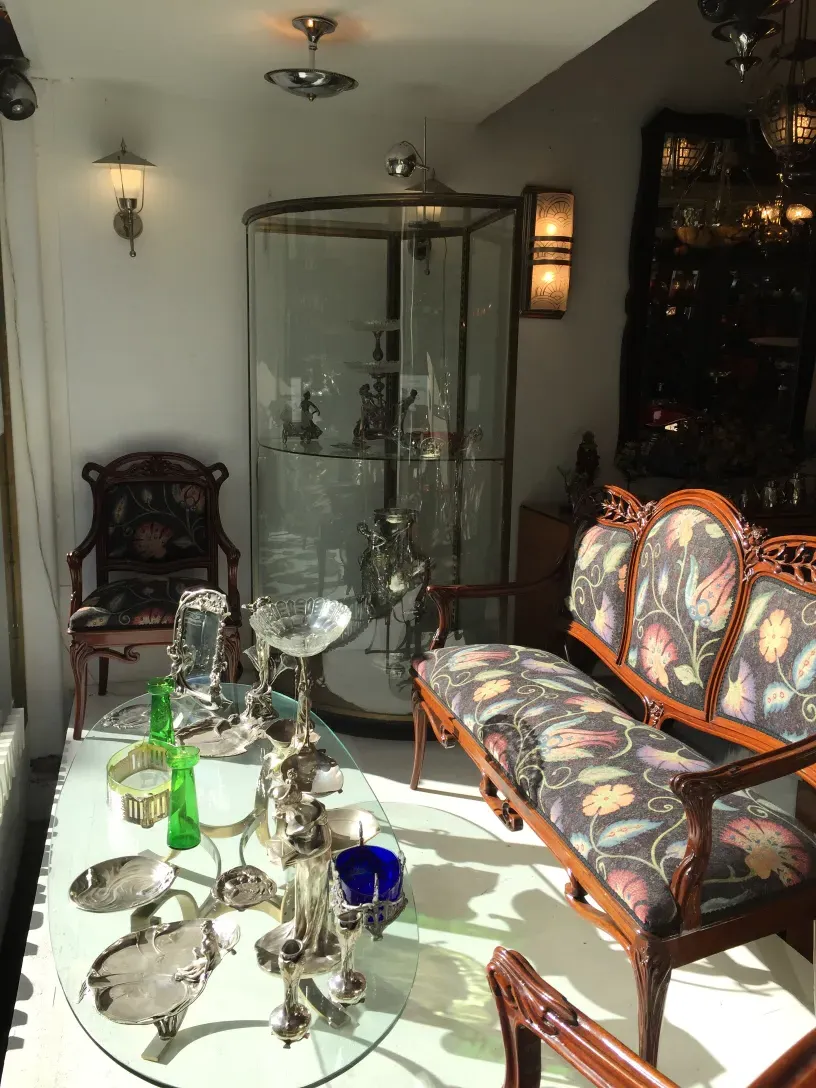 Three antique armchairs with floral design in a cozy setting.