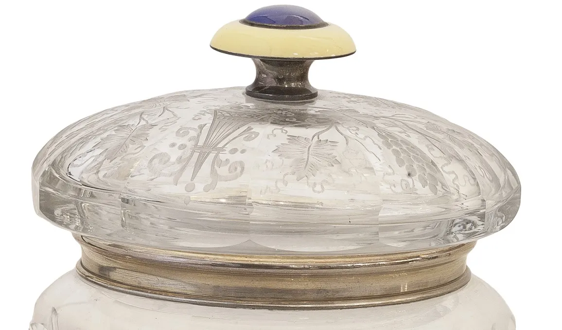 antique candy box featuring a decorative lid and round shape