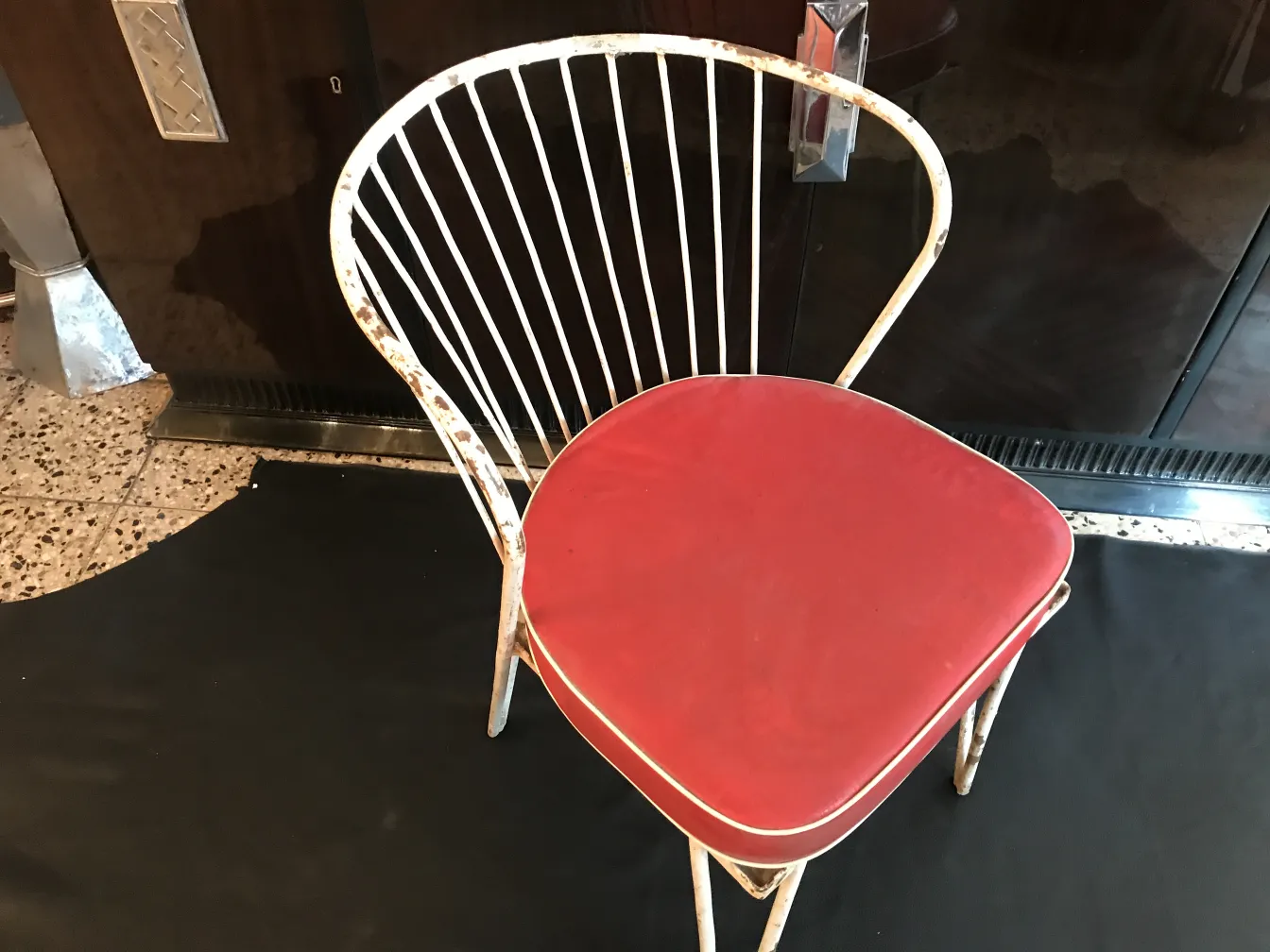 Old garden chair with a red seat, classic style brightens the space