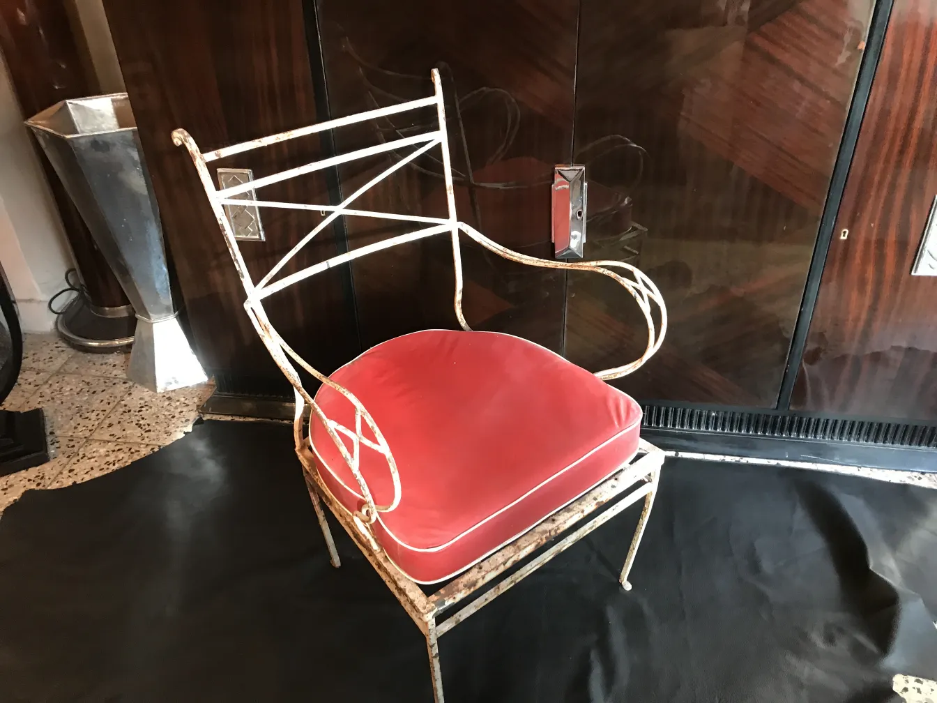 antique garden armchair with red seat in elegant setting