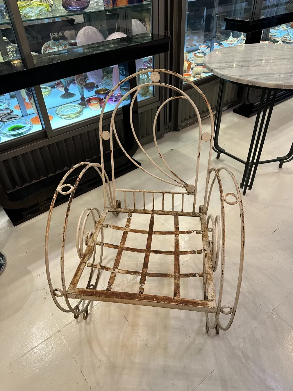 Three antique garden armchairs with elegant design in a cozy setting.