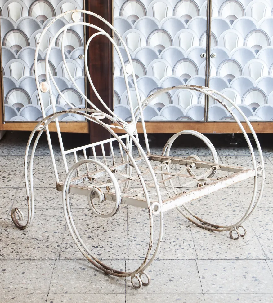 3 antique garden armchairs with curvy shapes in a cozy setting