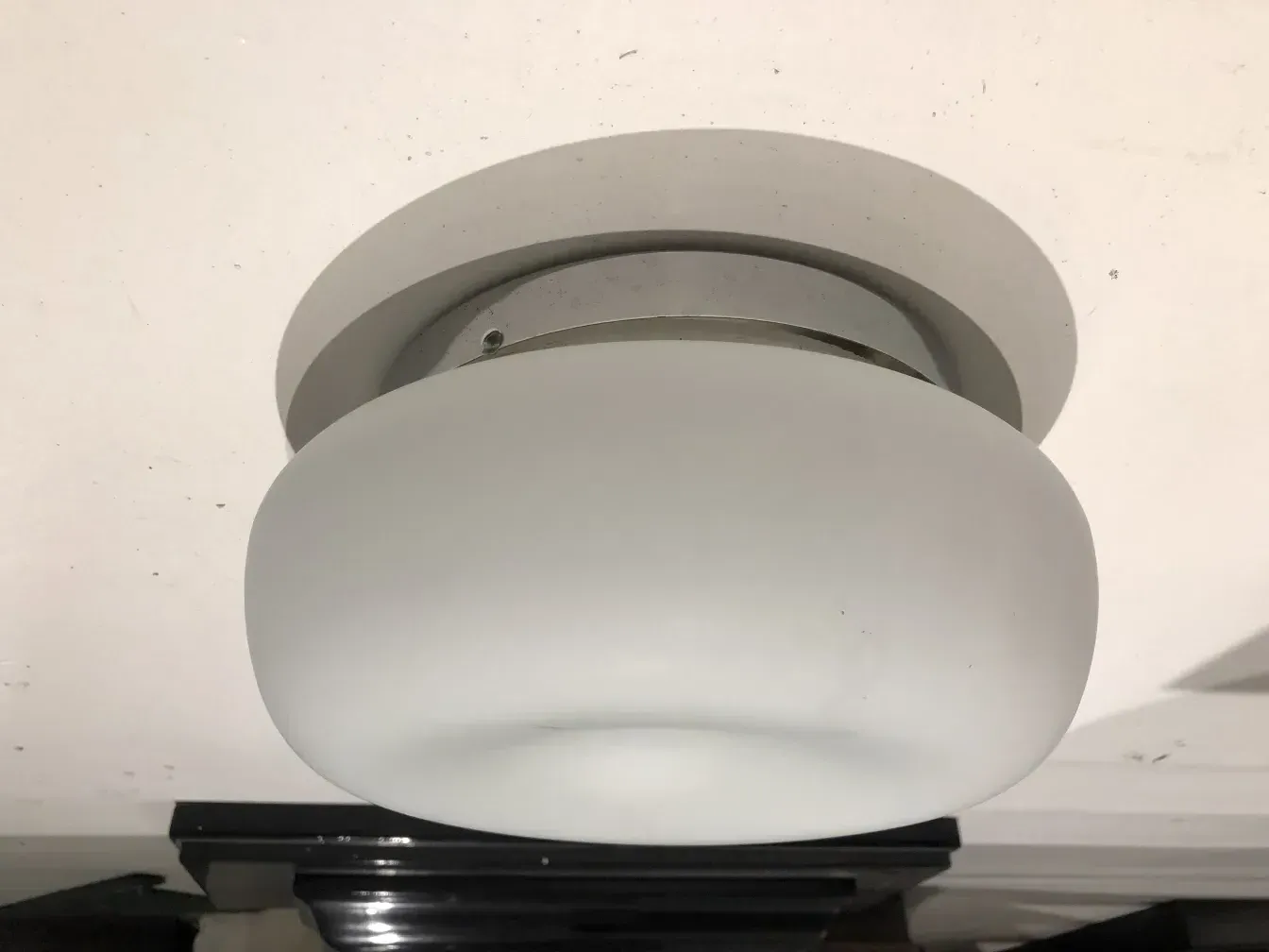 antique round ceiling light in a neutral setting