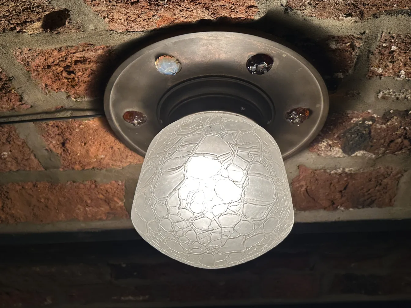 antique ceiling light illuminating a rustic setting