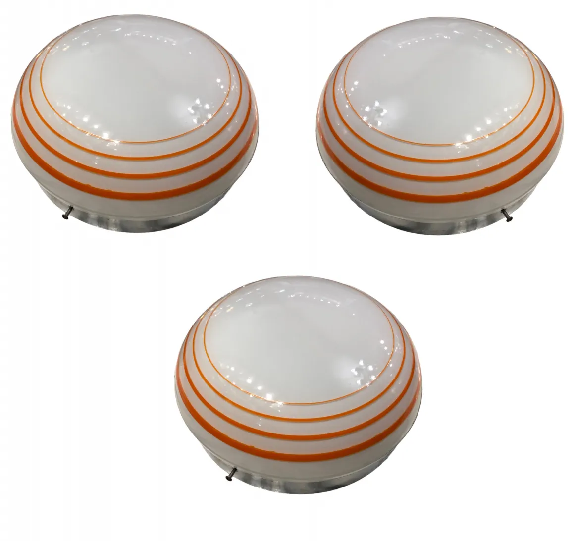 Three antique ceiling lights with decorative design in light colors.