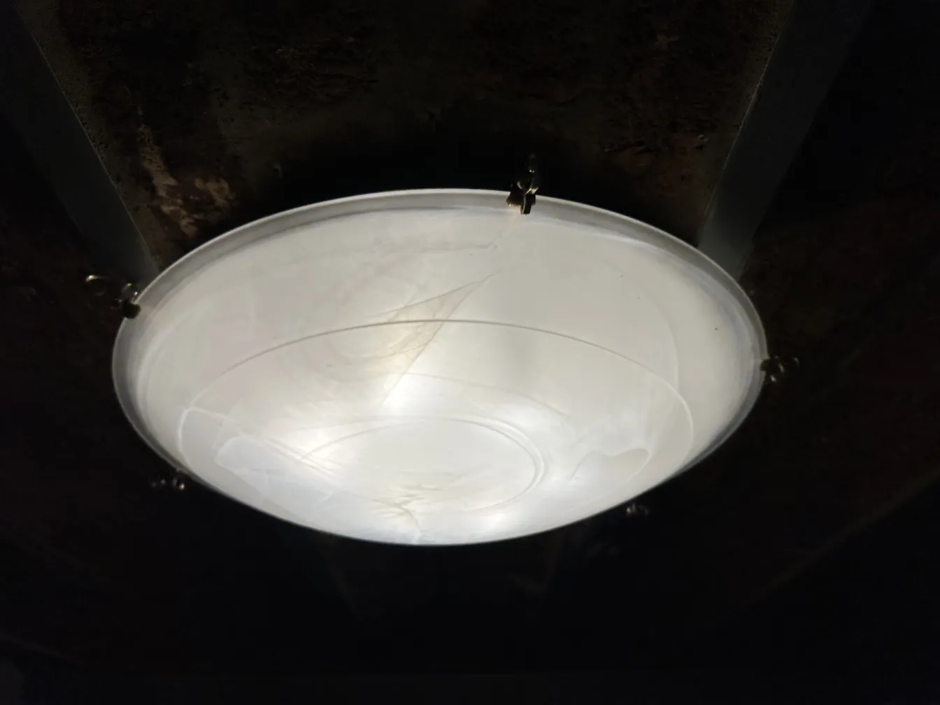 4 antique ceiling lights illuminating a dark environment