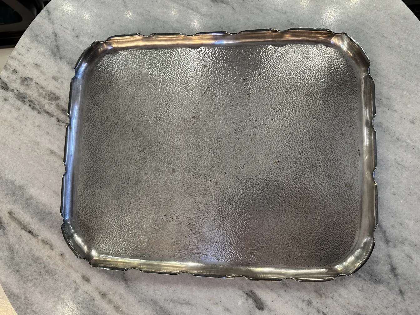 Antique tray with decorative design on marble