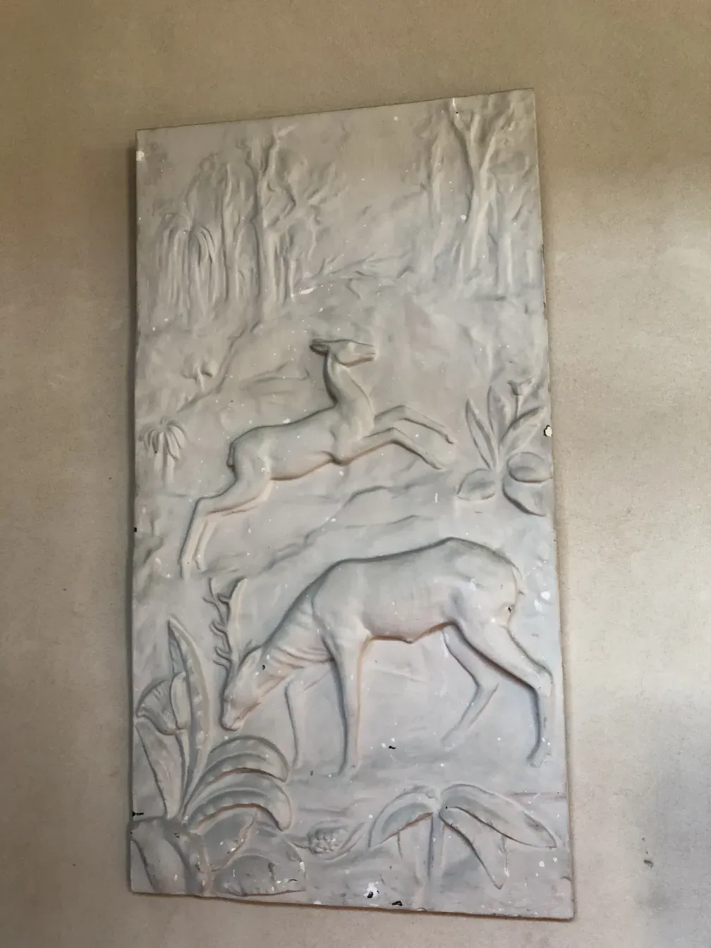 placa de parede antiga com relevos de cervos e folhagens