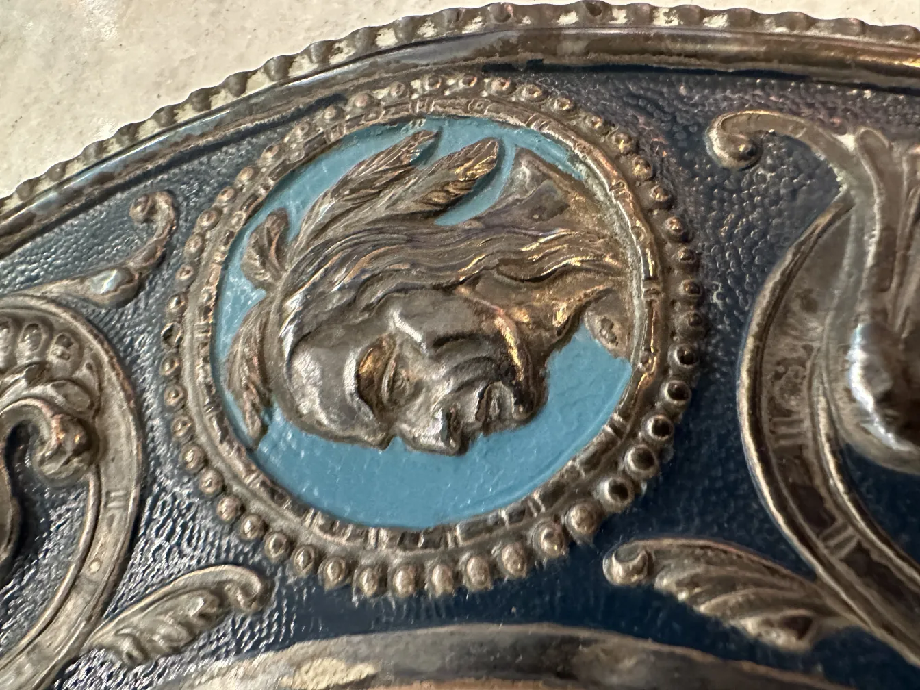 Antique wall plate featuring a raised portrait with a blue background