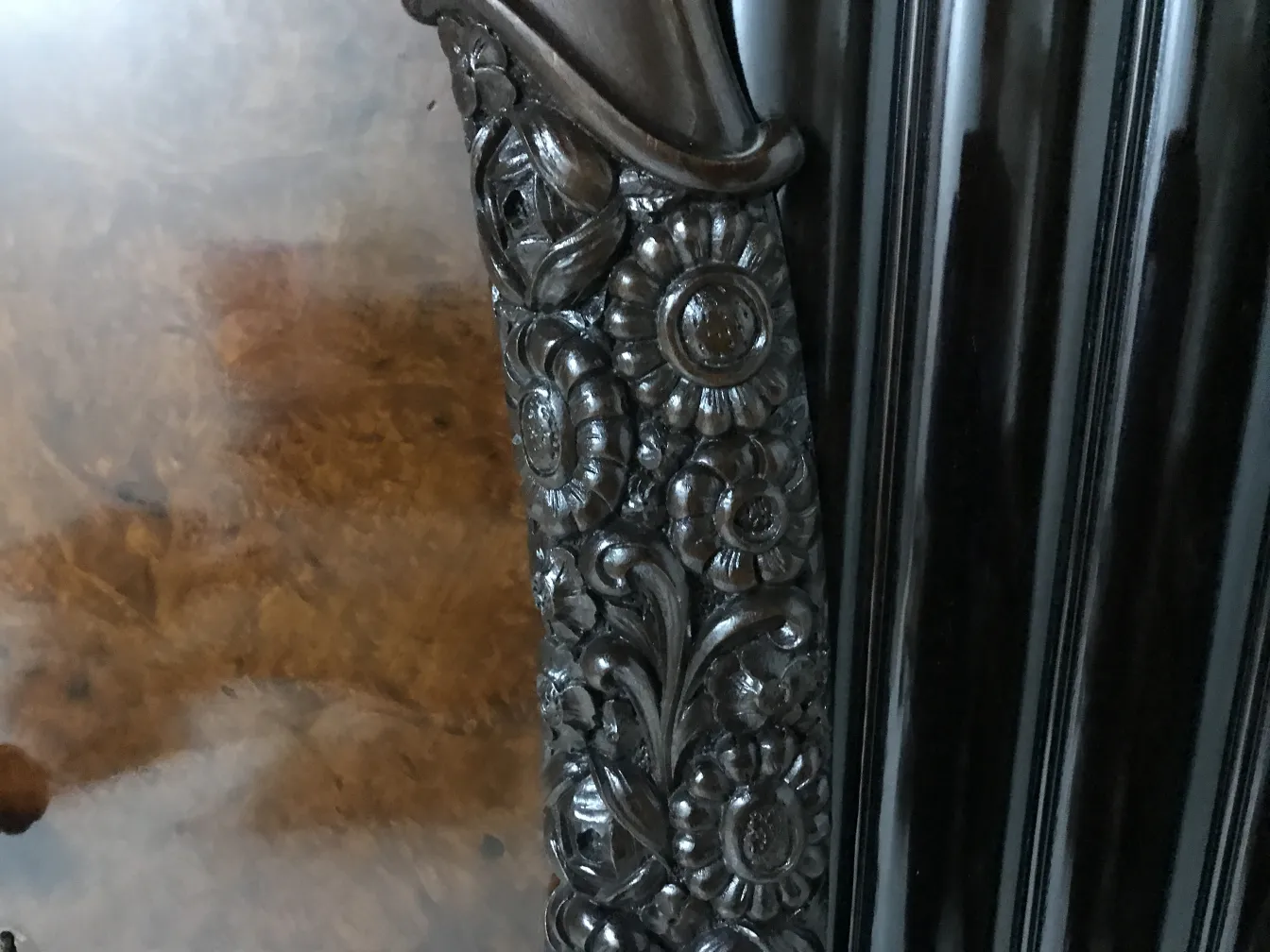 antique display cabinet featuring floral carvings