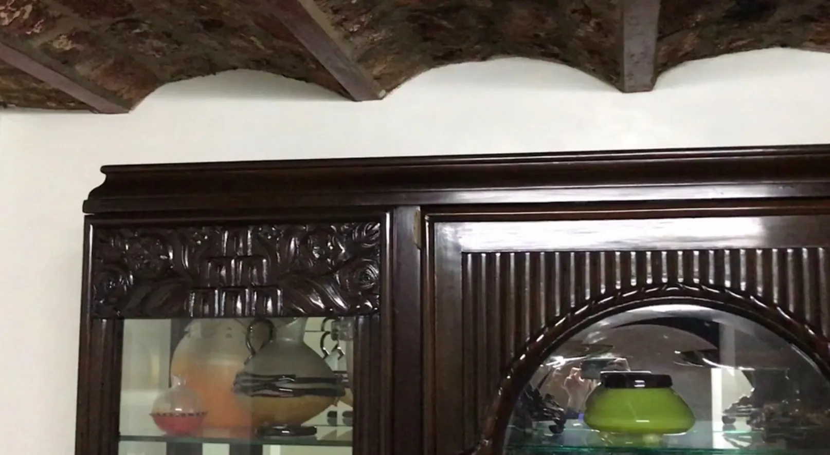 antique display cabinet with decorative details and lights