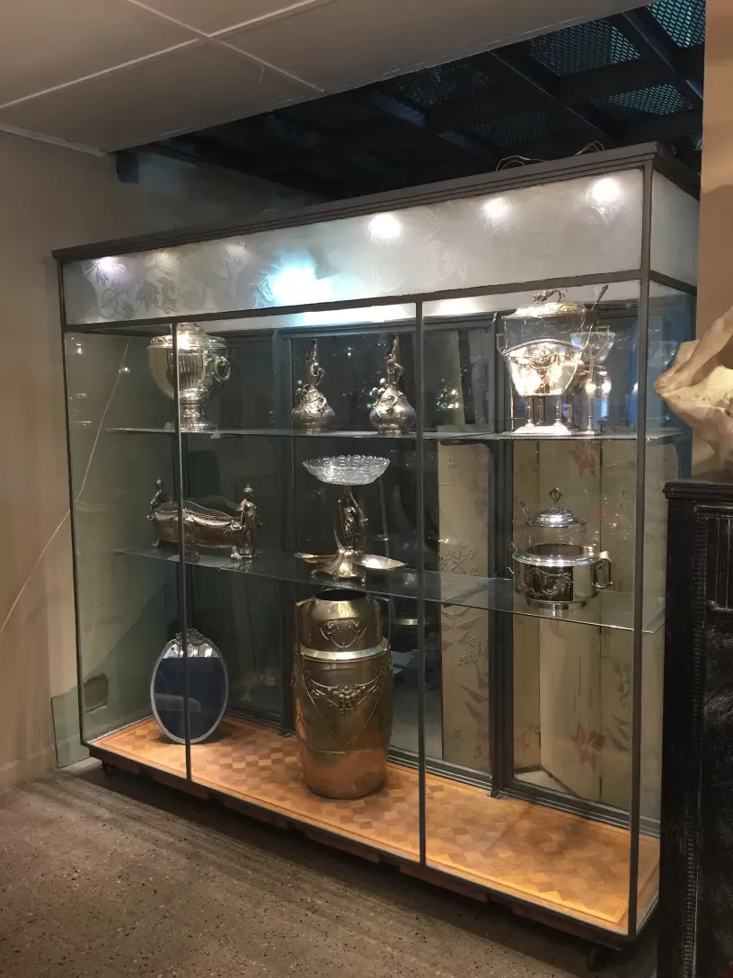 Antique display cabinet showcasing collectibles and decorative elements.