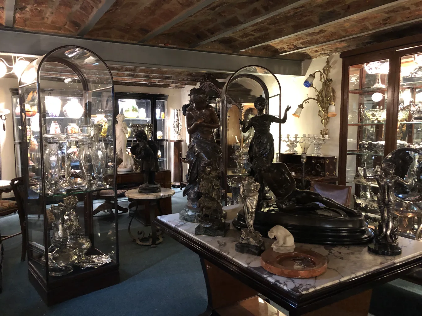 Antique display cabinet showcasing statues and elegant decor