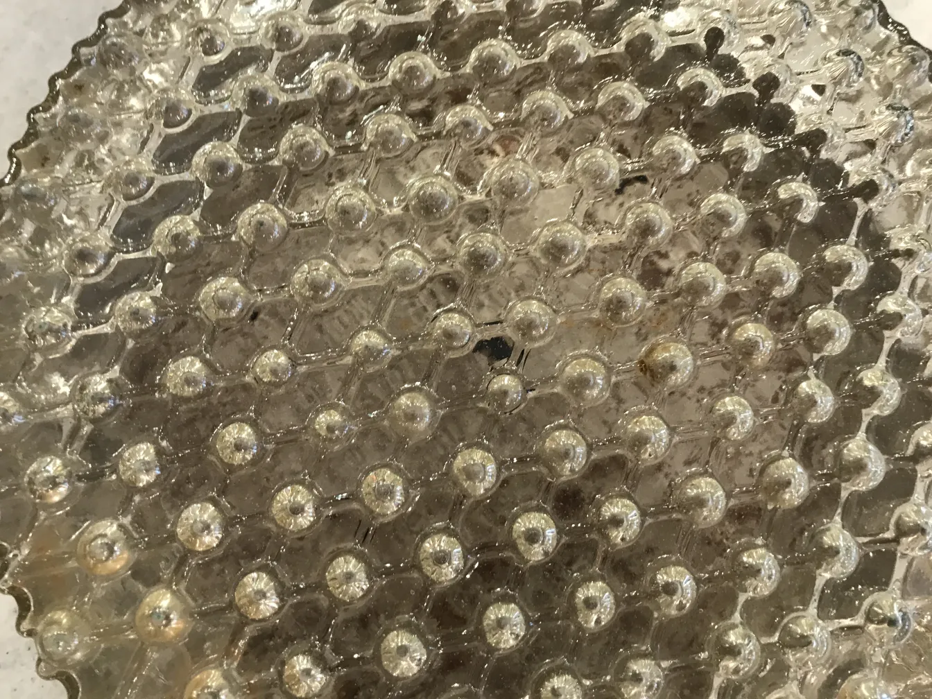 antique ceiling light with bubble shape in a lit environment