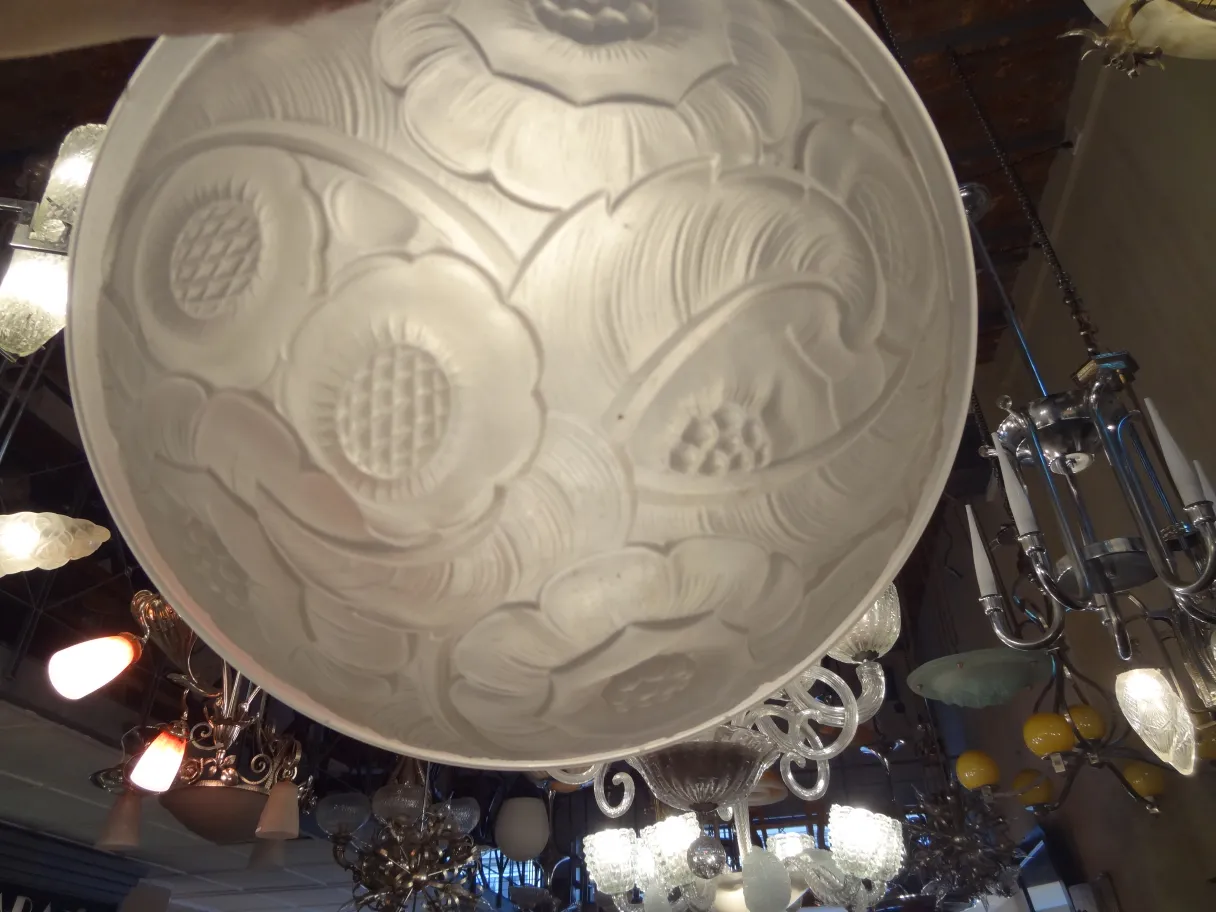 Antique ceiling light with floral design details.