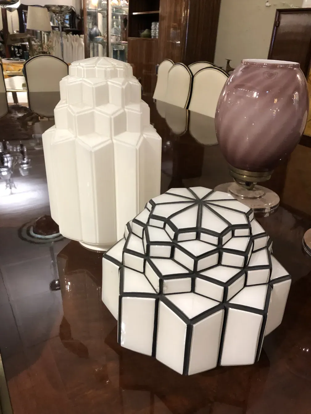 Two ceiling lights with geometric shapes in an elegant setting