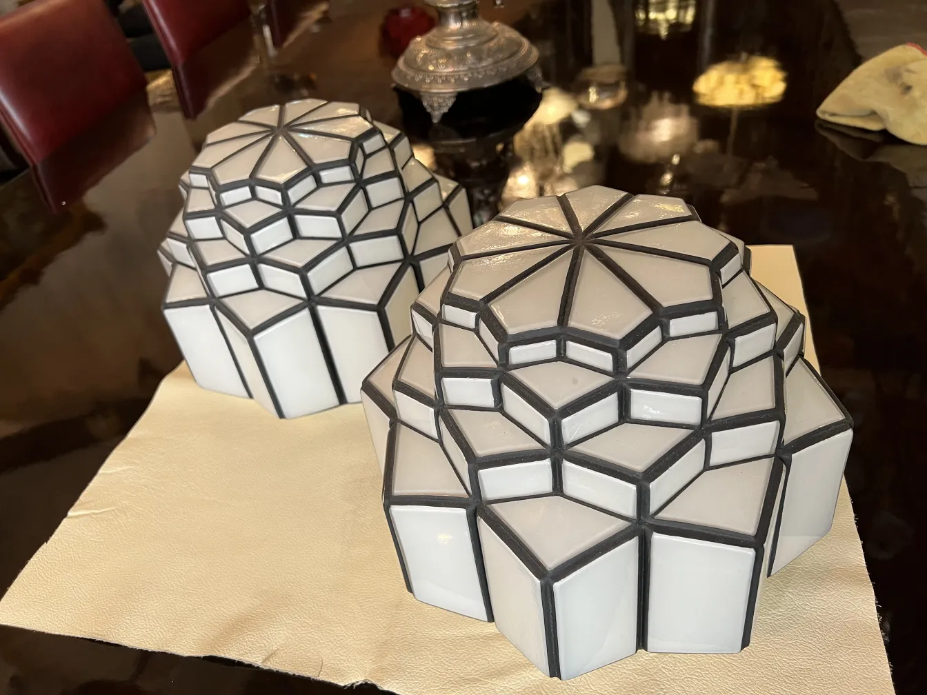 two antique ceiling lights with embossed design and light colors
