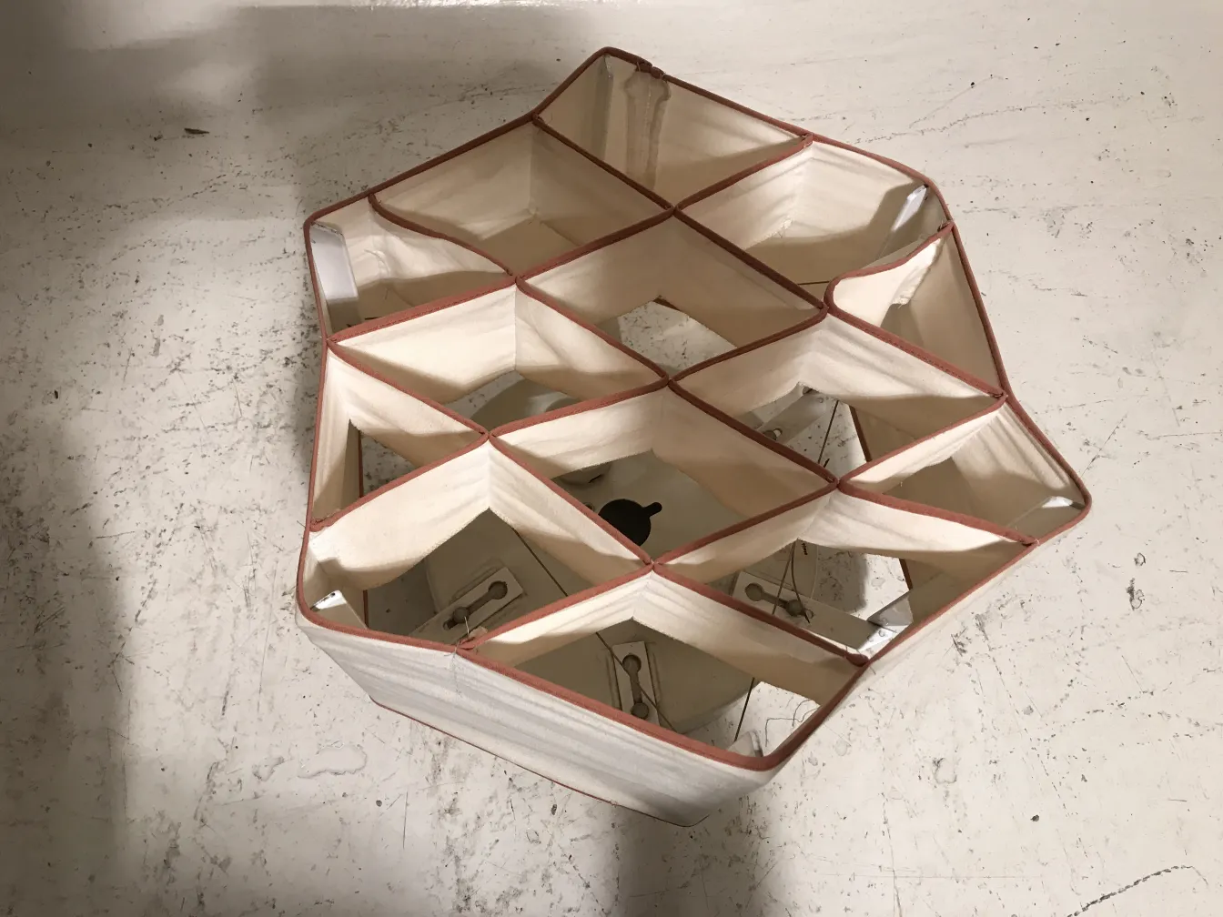 Two antique ceiling lights in a light color with hexagonal shape.