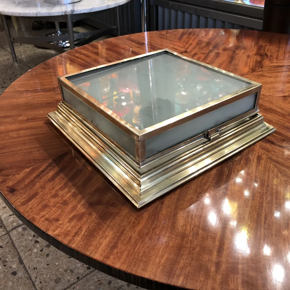 Two antique ceiling lights with decorative design on a table