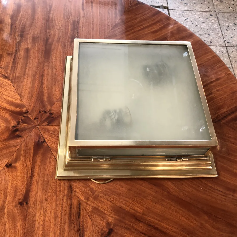 Two antique ceiling lights for illumination with a classic design on a wooden table.